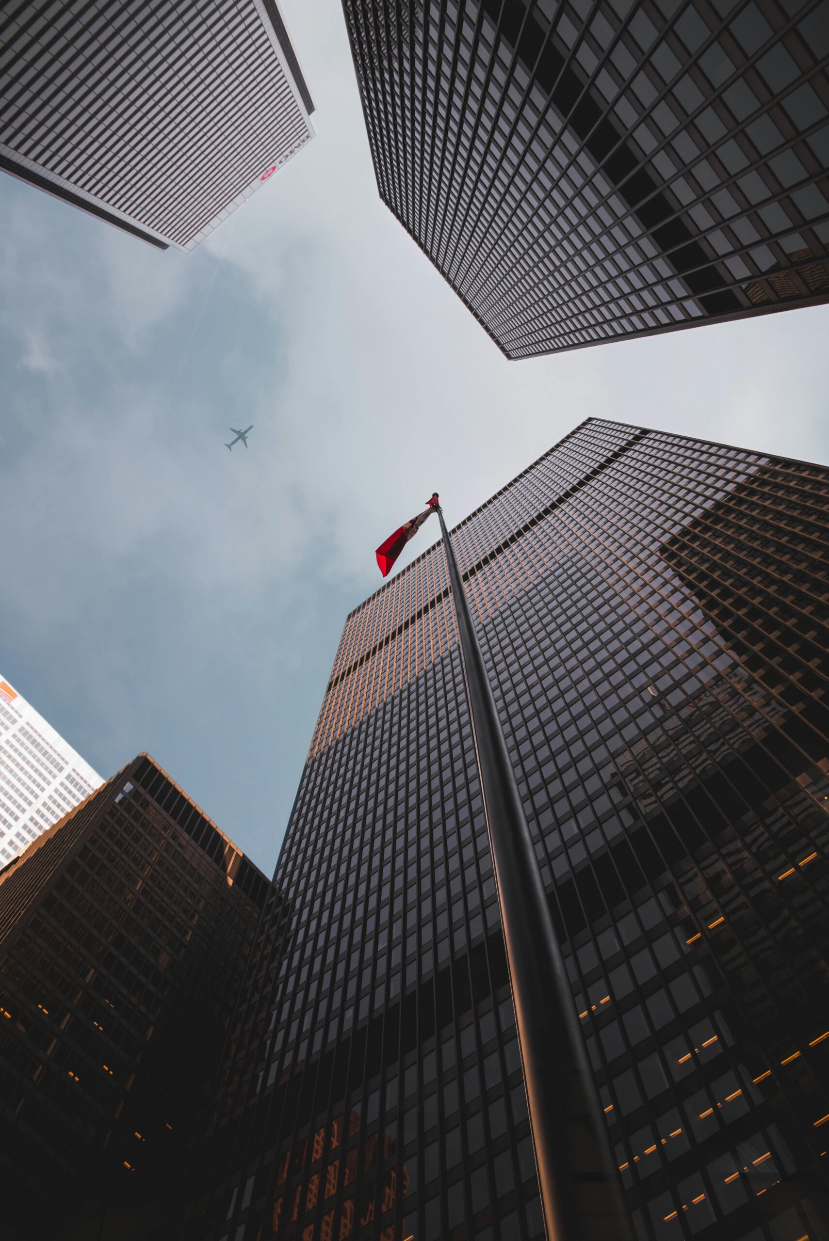 pexels-photo-2887582-2887582 Low angle of modern skyscrapers with a Canadian flag in downtown Toronto.